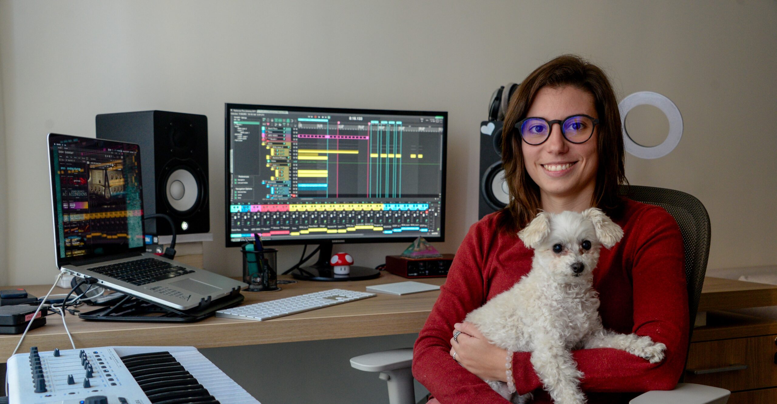 Vale Viola Firelight Audio working with her white dog on a sound design project focus
